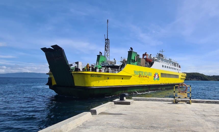 Yellow ferry arriving at a concrete pier